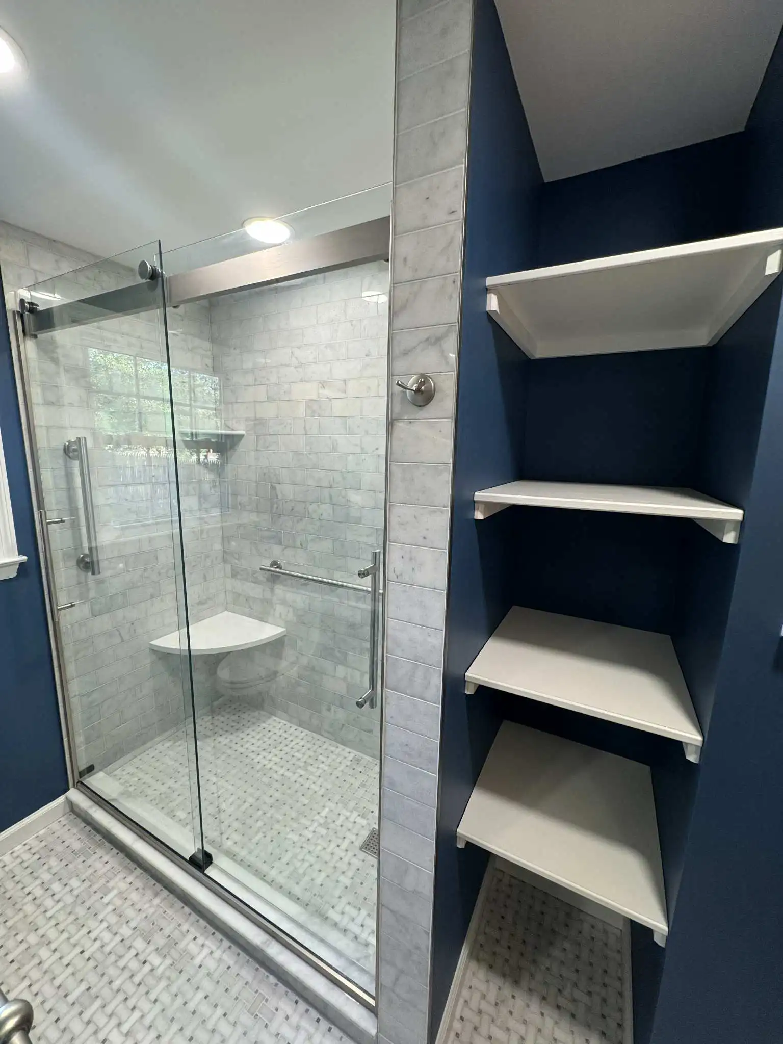 Detailed shower view featuring tilework, grout precision, and modern fixtures.