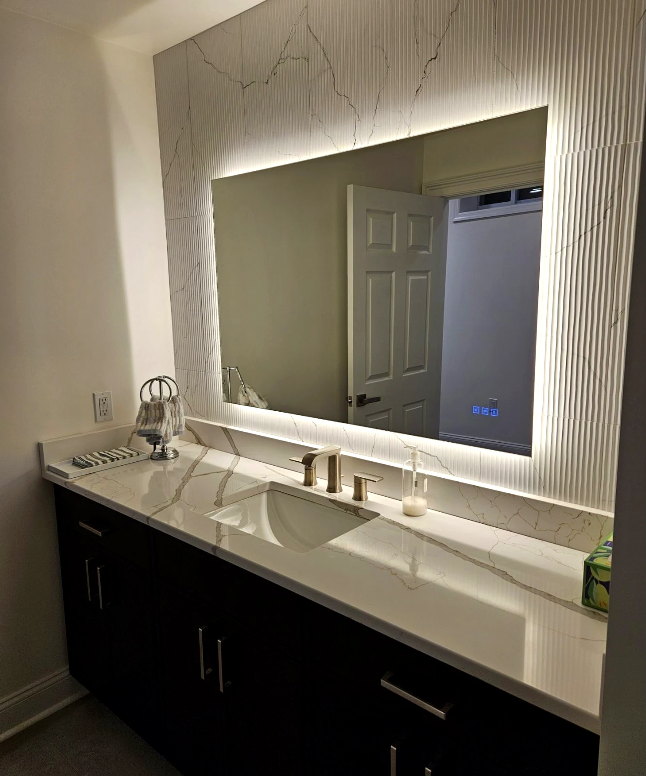 Bathroom vanity and mirror setup with clean finishes and modern lighting.